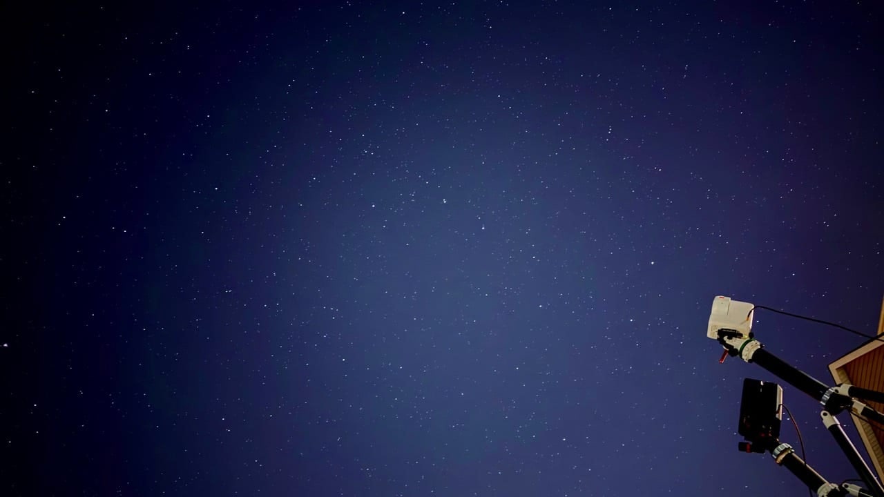Two Seestar telescopes under a starry backyard sky.